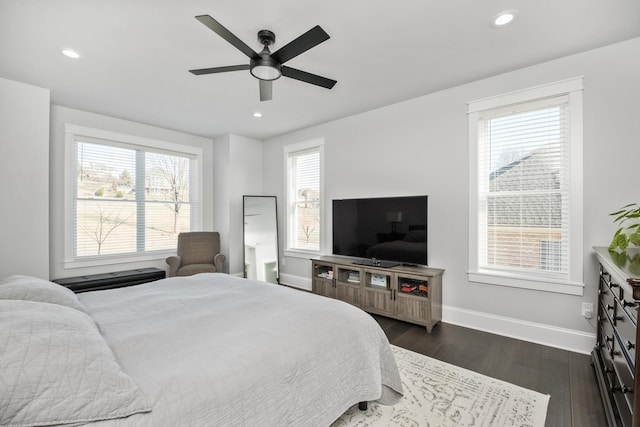 bedroom with baseboards, dark wood-type flooring, and recessed lighting