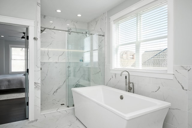 ensuite bathroom with a marble finish shower, marble finish floor, connected bathroom, and a freestanding bath