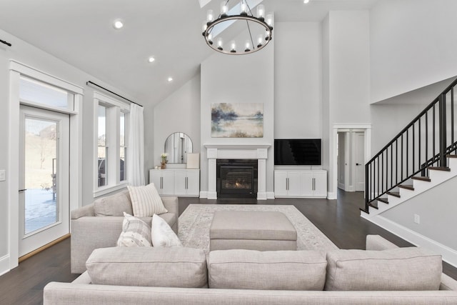 living area with dark wood-style flooring, stairway, high vaulted ceiling, and baseboards