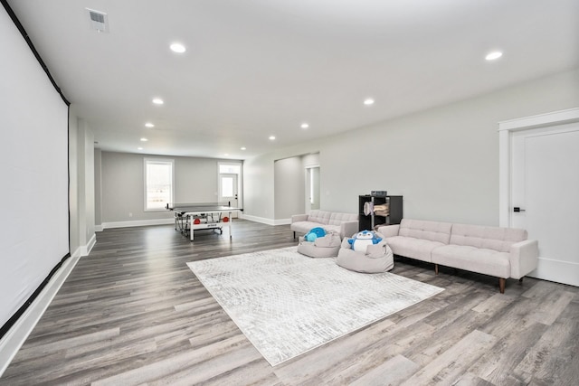 living area with visible vents, baseboards, wood finished floors, and recessed lighting