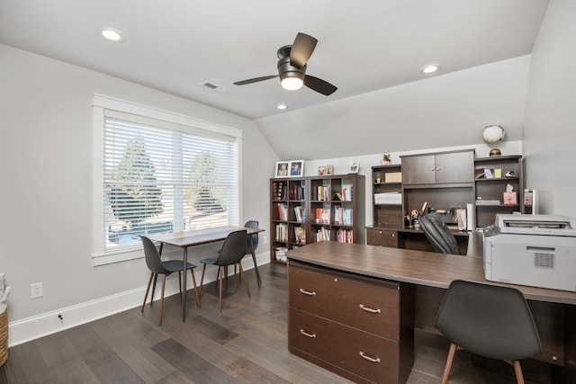 office space featuring ceiling fan, visible vents, baseboards, vaulted ceiling, and dark wood finished floors