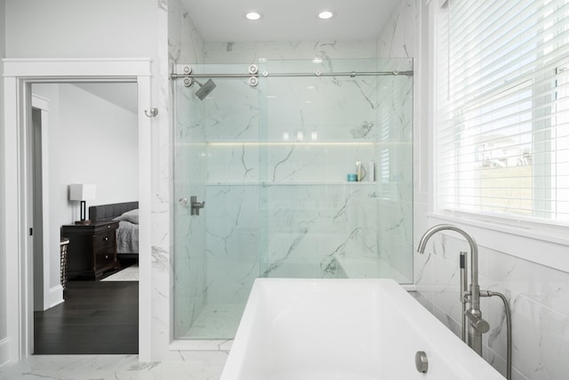 ensuite bathroom featuring a marble finish shower, a bathing tub, ensuite bathroom, marble finish floor, and recessed lighting