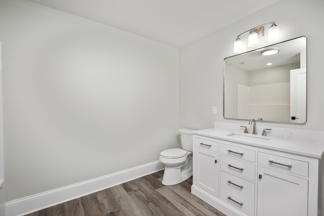 full bathroom featuring baseboards, a shower, toilet, wood finished floors, and vanity