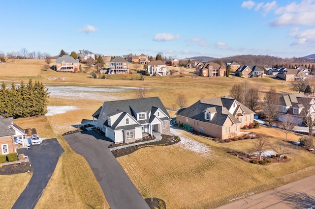 bird's eye view featuring a water view and a residential view