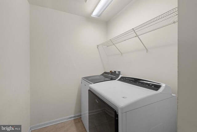 1708 Hudgins Farm Cir, Fredericksburg, VA 22408 - laundry area featuring washer and dryer and light tile patterned floors