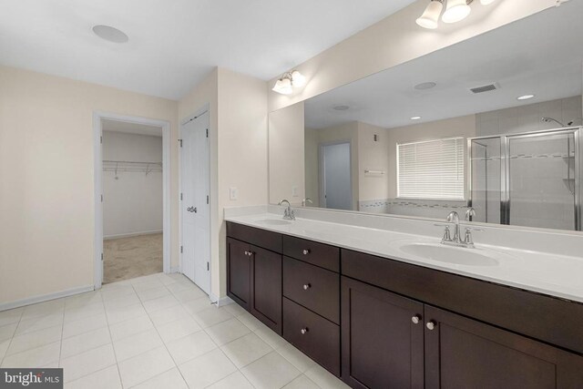 1708 Hudgins Farm Cir, Fredericksburg, VA 22408 - bathroom featuring a shower stall, double vanity, a walk in closet, and tile patterned floors