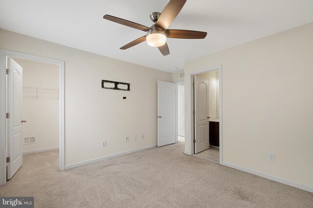 1708 Hudgins Farm Cir, Fredericksburg, VA 22408 - unfurnished bedroom featuring carpet, a walk in closet, a closet, a ceiling fan, and connected bathroom