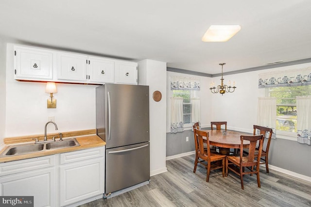 7934 Courthouse Rd, Spotsylvania, VA 22551 - kitchen featuring freestanding refrigerator, a sink, light wood finished floors, and white cabinetry