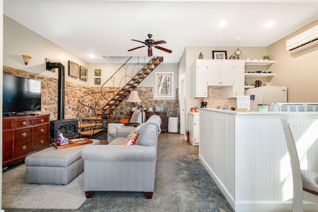 409 Lower Rawley Ln, Hinton, VA 22831 - living room featuring a wall mounted AC, stairway, finished concrete flooring, ceiling fan, and a wood stove