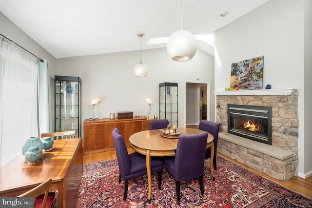 108 Harris Ct, Locust Grove, VA 22508 - dining room featuring lofted ceiling, a fireplace, and wood finished floors