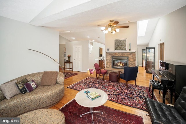 108 Harris Ct, Locust Grove, VA 22508 - living room with vaulted ceiling, wood finished floors, ceiling fan, and a fireplace