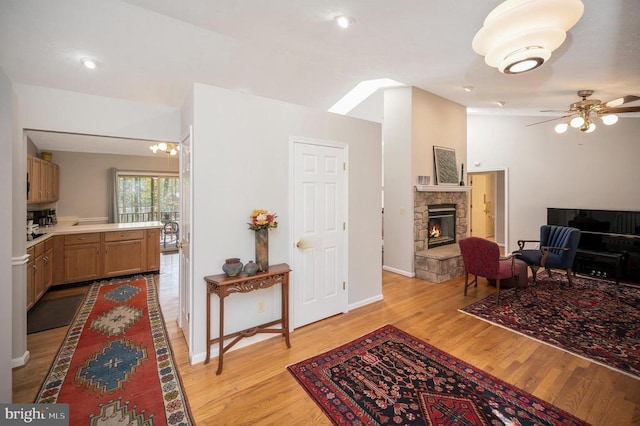 108 Harris Ct, Locust Grove, VA 22508 - living room with light wood-type flooring, a fireplace, a ceiling fan, and baseboards