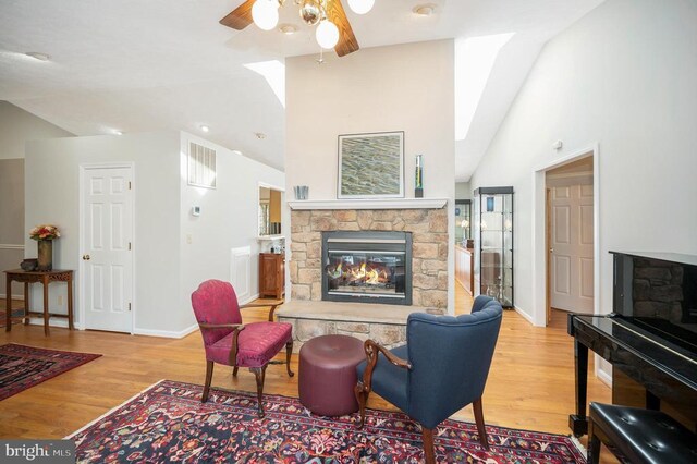 108 Harris Ct, Locust Grove, VA 22508 - living area featuring a fireplace, lofted ceiling, ceiling fan, wood finished floors, and baseboards