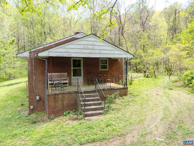 331 Finks Hollow Ln, Syria, VA 22743 - bungalow-style home with covered porch, a wooded view, and brick siding