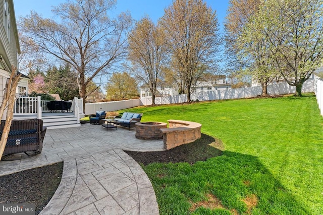 view of yard featuring a fire pit, a patio, and a deck