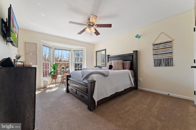 carpeted bedroom with baseboards and a ceiling fan