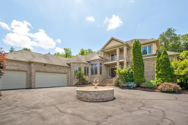 3417 Lake Pointe Dr, Rockingham, VA 22801 - view of front facade with brick siding, a balcony, an attached garage, and driveway