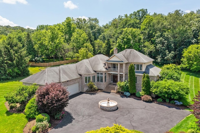 3417 Lake Pointe Dr, Rockingham, VA 22801 - view of front of home with an attached garage, driveway, a chimney, and brick siding