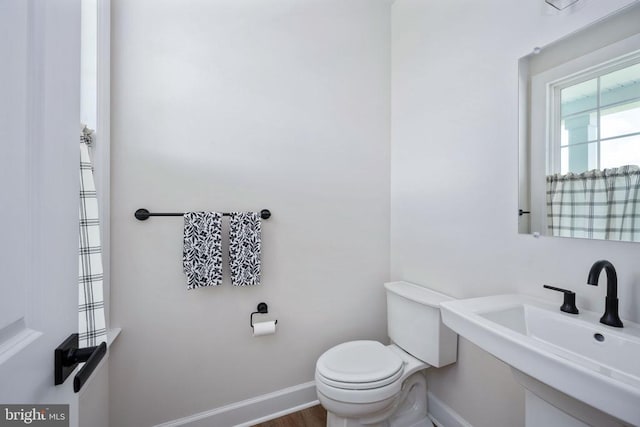 11207 Redlands Trl, Spotsylvania, VA 22551 - half bathroom featuring toilet, baseboards, a sink, and wood finished floors