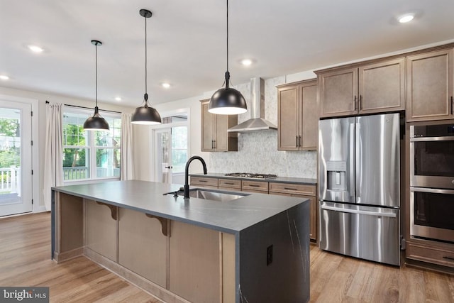 11207 Redlands Trl, Spotsylvania, VA 22551 - kitchen with stainless steel appliances, wall chimney exhaust hood, a sink, light wood-type flooring, and recessed lighting