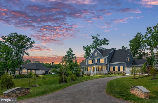 11207 Redlands Trl, Spotsylvania, VA 22551 - view of front facade with a lawn, curved driveway, and covered porch