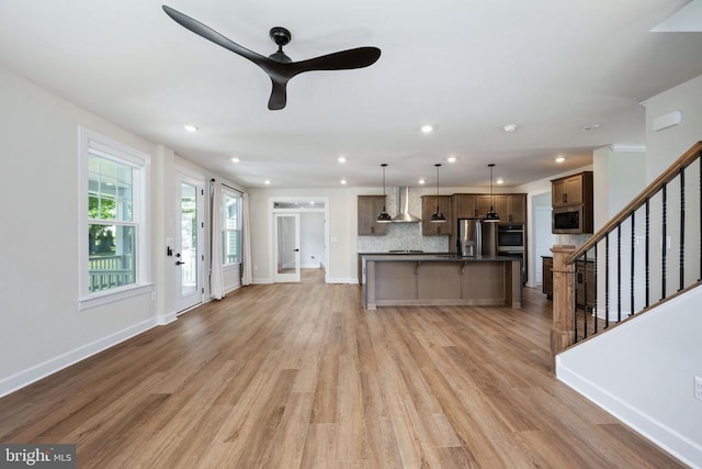 11207 Redlands Trl, Spotsylvania, VA 22551 - unfurnished living room with ceiling fan, light wood-style floors, stairway, recessed lighting, and baseboards