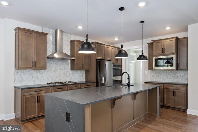 11207 Redlands Trl, Spotsylvania, VA 22551 - kitchen with wall chimney range hood, a sink, dark countertops, stainless steel appliances, and backsplash