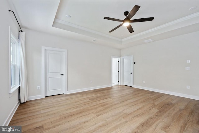 11207 Redlands Trl, Spotsylvania, VA 22551 - spare room featuring a raised ceiling, light wood-style floors, ceiling fan, crown molding, and baseboards