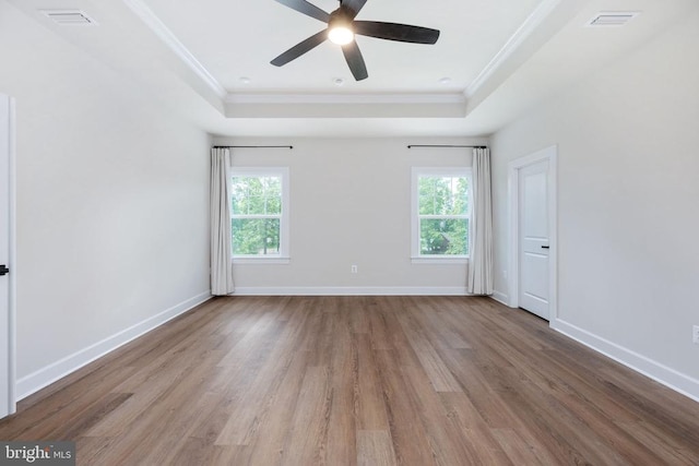 11207 Redlands Trl, Spotsylvania, VA 22551 - empty room featuring a raised ceiling, ornamental molding, wood finished floors, ceiling fan, and baseboards