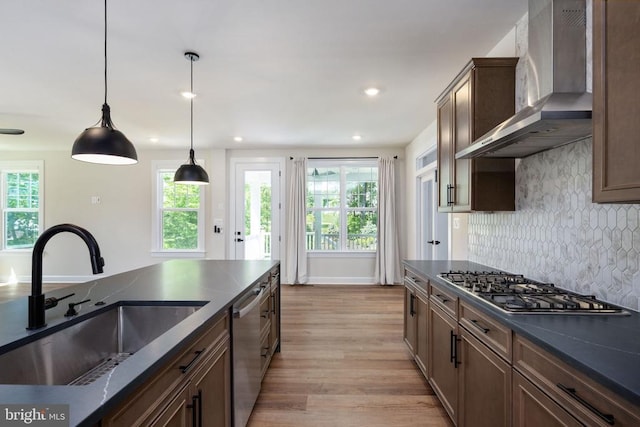 11207 Redlands Trl, Spotsylvania, VA 22551 - kitchen featuring wall chimney range hood, a sink, stainless steel appliances, dark countertops, and decorative backsplash