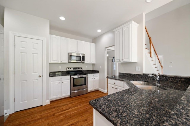 239 Windsor Dr, Fishersville, VA 22939 - kitchen with stainless steel appliances, dark wood-style floors, white cabinets, dark stone counters, and recessed lighting