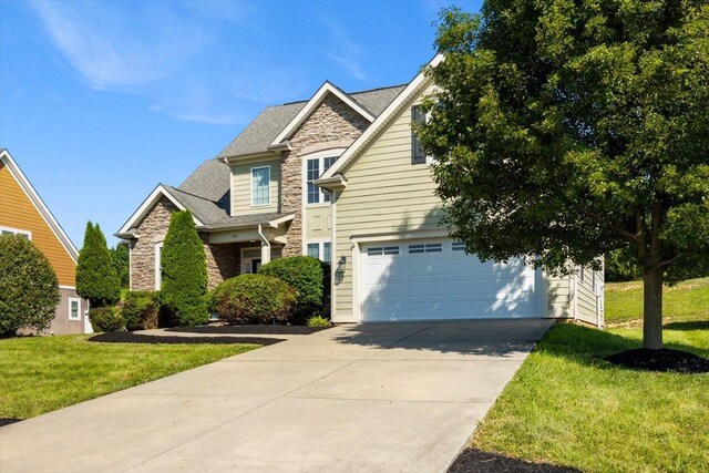 239 Windsor Dr, Fishersville, VA 22939 - view of front facade featuring stone siding, concrete driveway, a front lawn, and an attached garage