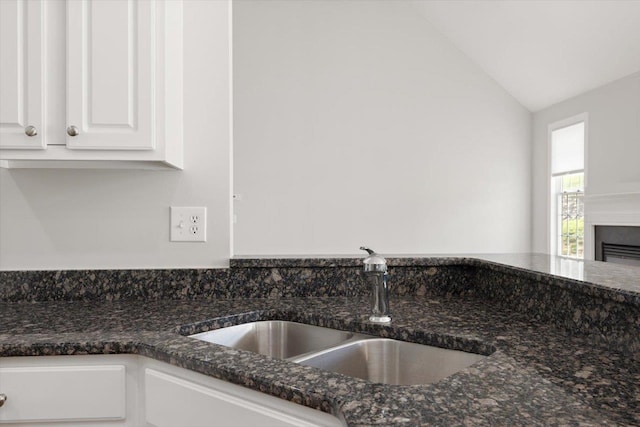 239 Windsor Dr, Fishersville, VA 22939 - detailed view of white cabinets, dark stone counters, and a fireplace