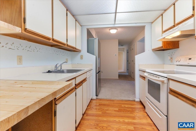 kitchen with a sink, white cabinetry, white appliances, under cabinet range hood, and light countertops