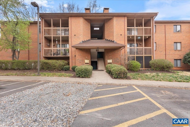 view of building exterior with uncovered parking