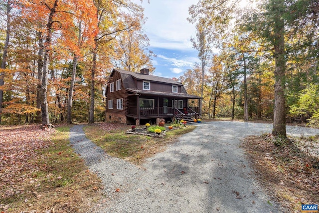 2395 Mountain Brook Dr, Charlottesville, VA 22902 - view of front of home with covered porch, log siding, a chimney, and driveway