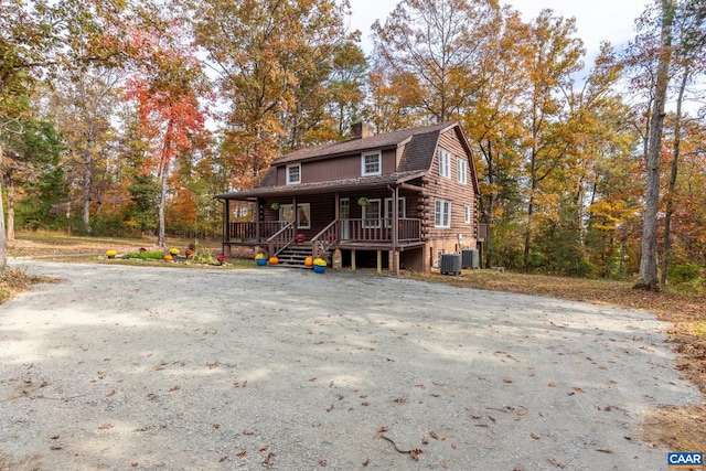 2395 Mountain Brook Dr, Charlottesville, VA 22902 - view of front of property with a chimney, a gambrel roof, log siding, covered porch, and central air condition unit