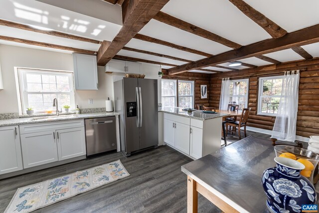 2395 Mountain Brook Dr, Charlottesville, VA 22902 - kitchen featuring a sink, a peninsula, dark wood-style flooring, rustic walls, and appliances with stainless steel finishes