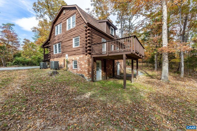2395 Mountain Brook Dr, Charlottesville, VA 22902 - view of property exterior featuring cooling unit, brick siding, log siding, and a deck