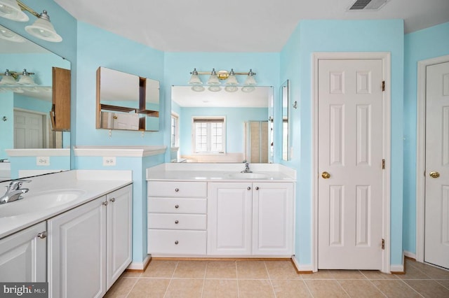 5606 Joshua Tree Cir, Fredericksburg, VA 22407 - full bath featuring tile patterned floors, two vanities, a stall shower, and baseboards