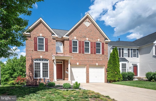 5606 Joshua Tree Cir, Fredericksburg, VA 22407 - colonial inspired home with brick siding, driveway, an attached garage, and a front yard