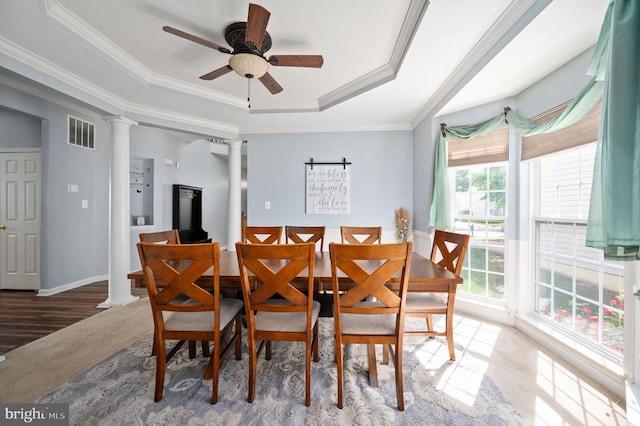 5606 Joshua Tree Cir, Fredericksburg, VA 22407 - carpeted dining room with a ceiling fan, ornamental molding, a tray ceiling, baseboards, and ornate columns