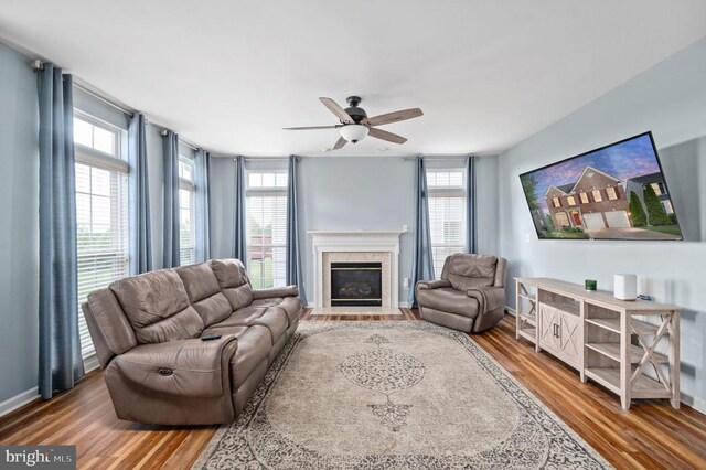 5606 Joshua Tree Cir, Fredericksburg, VA 22407 - living area with wood finished floors, healthy amount of natural light, and a fireplace with flush hearth