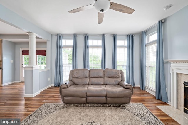 5606 Joshua Tree Cir, Fredericksburg, VA 22407 - living area with decorative columns, a premium fireplace, plenty of natural light, and wood finished floors