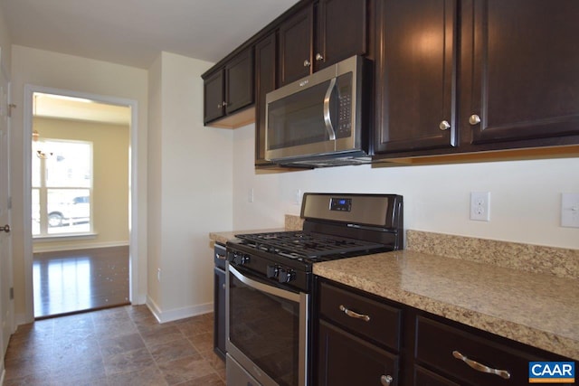 1193 Shenandoah Crossing Dr, Gordonsville, VA 22942 - kitchen featuring dark brown cabinetry, stainless steel appliances, baseboards, and light countertops