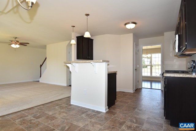 1193 Shenandoah Crossing Dr, Gordonsville, VA 22942 - kitchen featuring a peninsula, ceiling fan, a kitchen bar, stone finish flooring, and baseboards