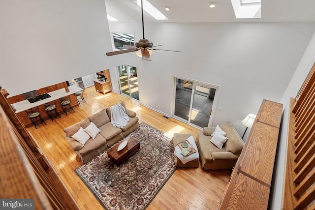 13013 Alum Springs Rd, Culpeper, VA 22701 - living area with a skylight, a towering ceiling, light wood-style floors, a ceiling fan, and recessed lighting