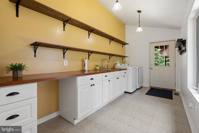 13013 Alum Springs Rd, Culpeper, VA 22701 - washroom featuring washer and dryer, cabinet space, light tile patterned floors, and baseboards