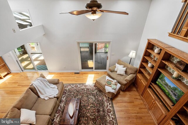 13013 Alum Springs Rd, Culpeper, VA 22701 - living room featuring a towering ceiling, wood finished floors, a ceiling fan, and baseboards