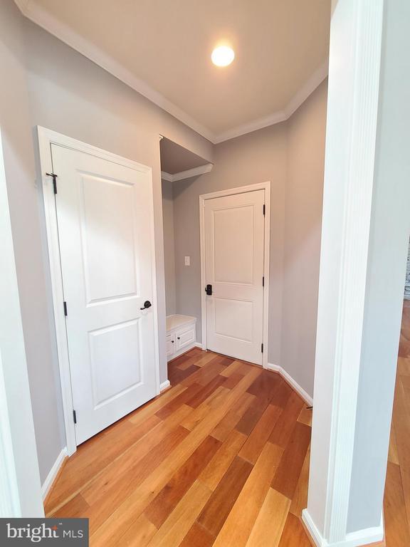 9423 Reservoir Rd, Fredericksburg, VA 22407 - corridor with ornamental molding and light wood-type flooring
